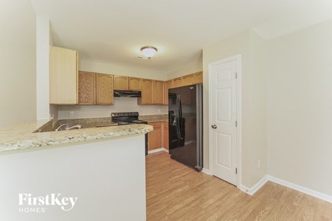a kitchen with a counter top and a refrigerator