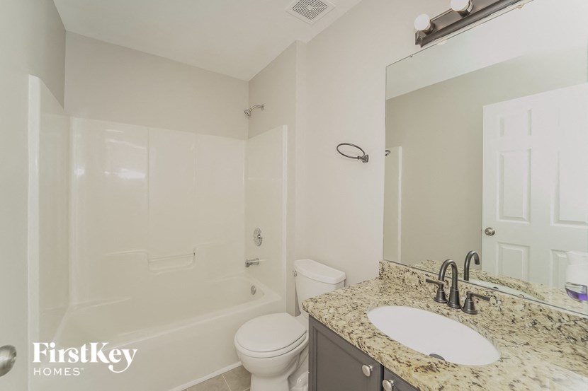 a bathroom with a sink toilet and a shower