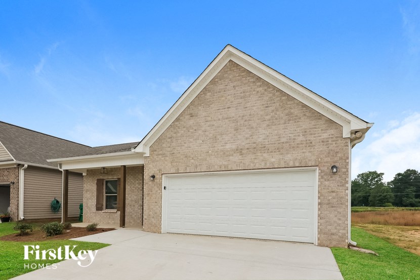 A house with a garage door and a sign that says "FirstKey Homes".