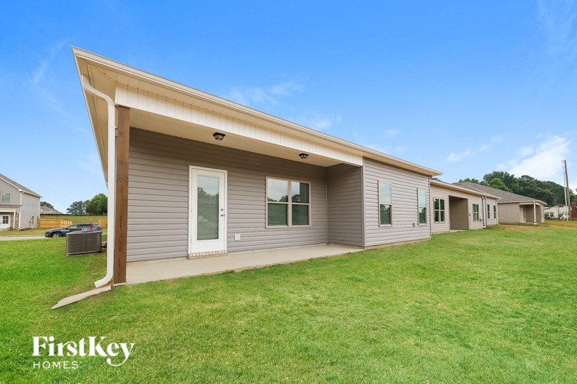 A modern house with a large front yard is for sale by FirstKey Homes.