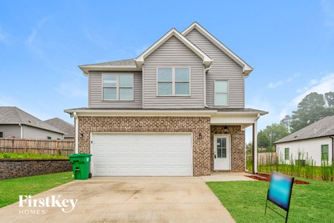 the front of a house with a white garage door