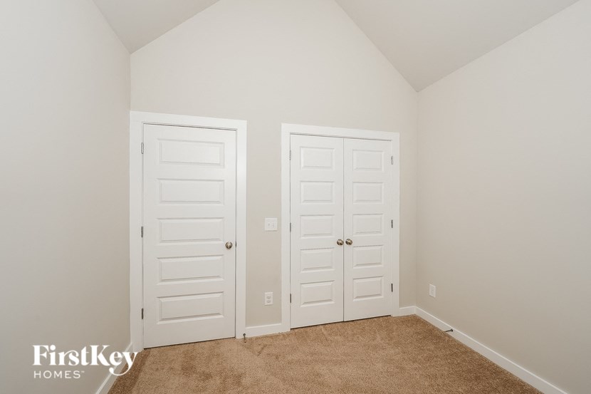 a bedroom with two closets and two white doors