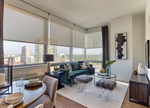 A modern living room with a dining table set for two.