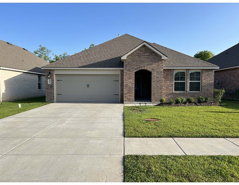 a house with a driveway and a garage door