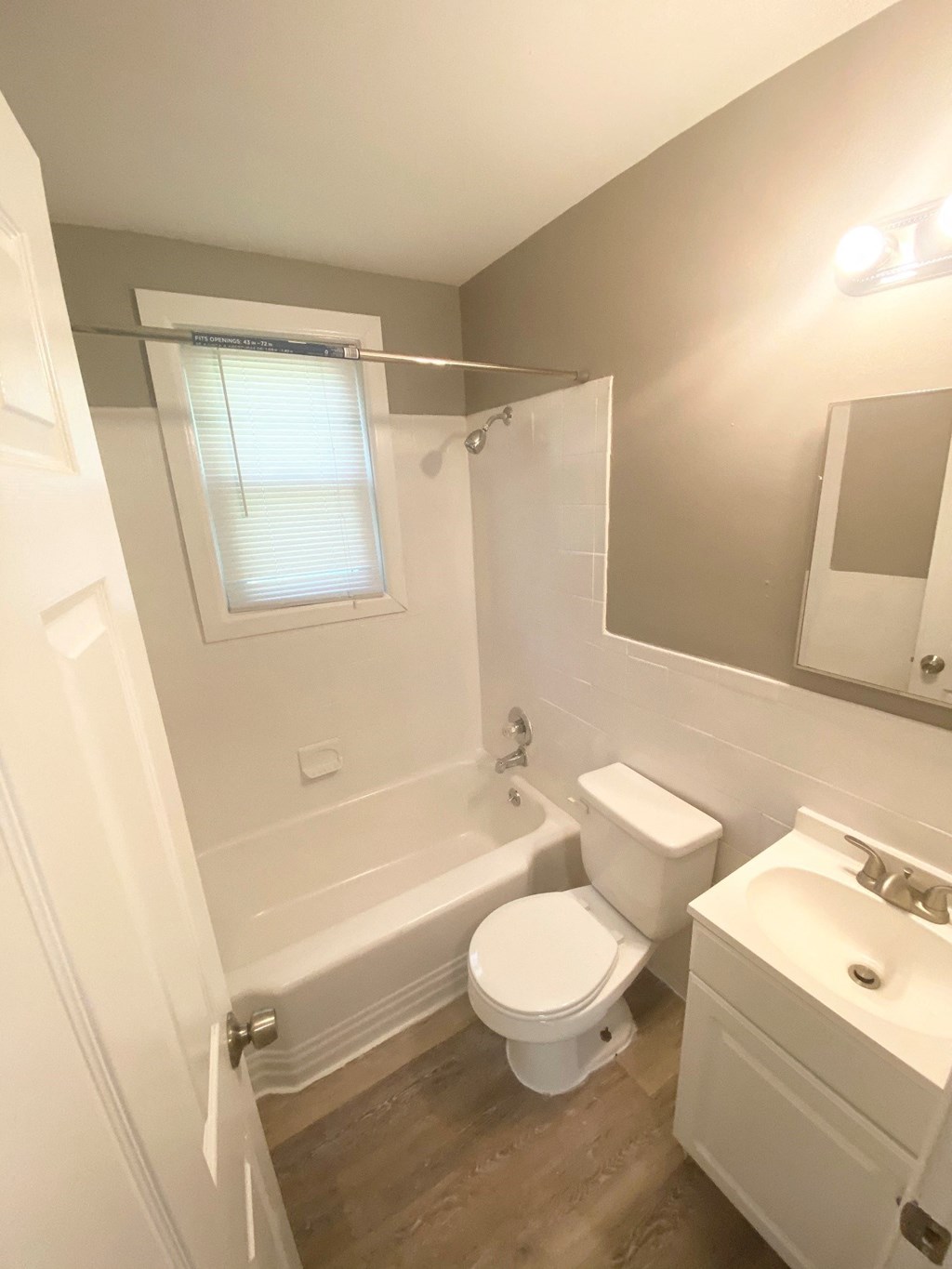 a bathroom with a toilet and a tub and a sink