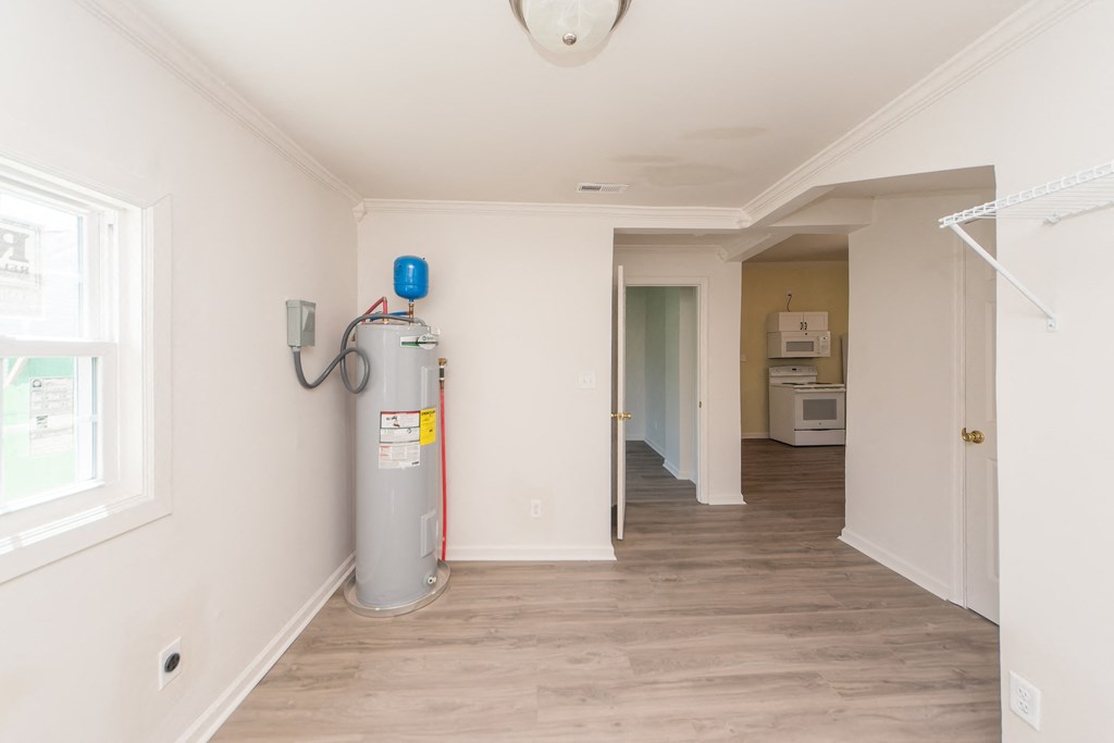 an empty room with a water heater in it