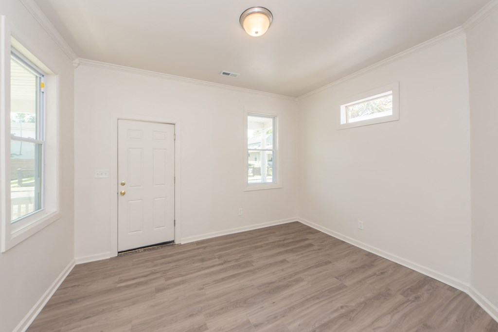 an empty room with white walls and a white door