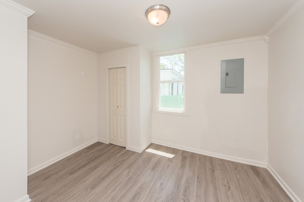 an empty room with white walls and a window