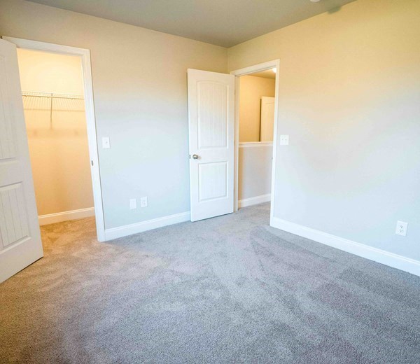 an empty room with a closet and a door