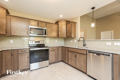 A kitchen with wooden cabinets and stainless steel appliances.