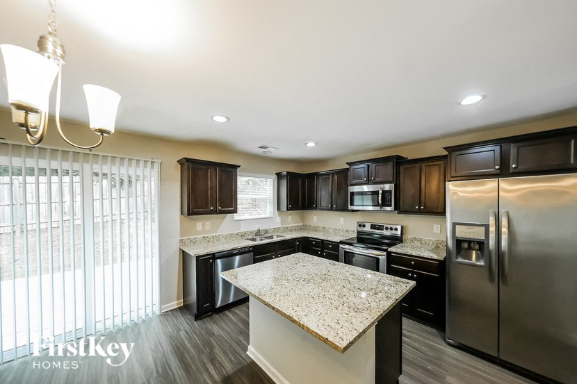 a kitchen with stainless steel appliances and granite counter tops