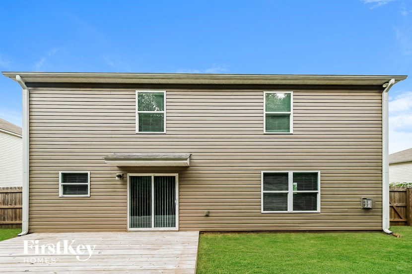 a house with a wooden deck and a yard