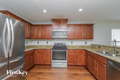 a kitchen with wooden cabinets and stainless steel appliances