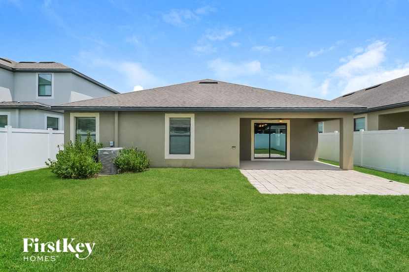 a house with a grass yard and a patio