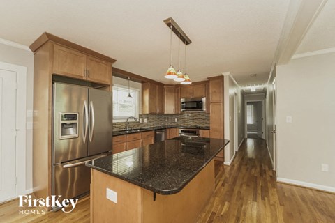 a kitchen with stainless steel appliances and granite counter tops
