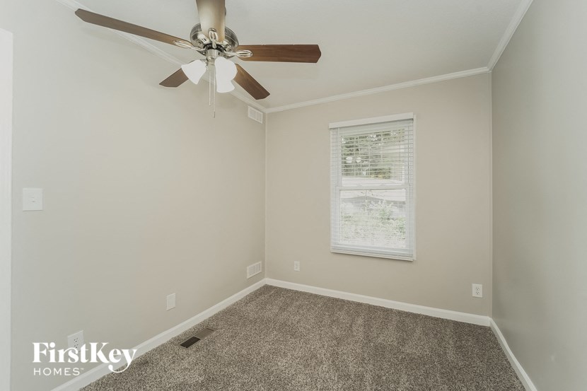 a room with a ceiling fan and a window