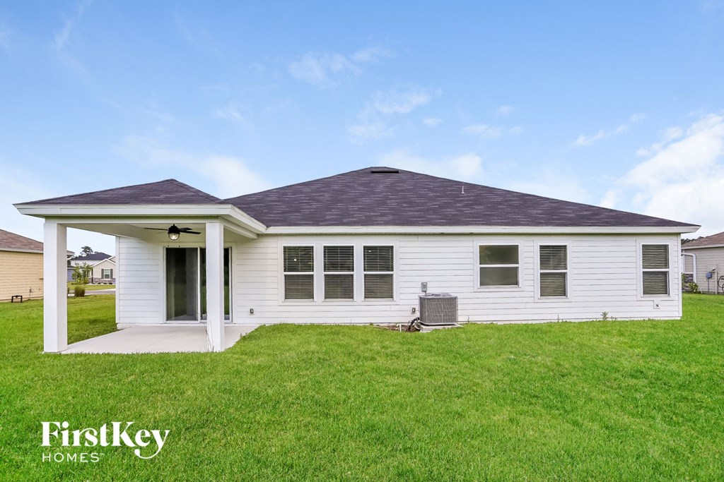 a white house with a porch and a grassy yard