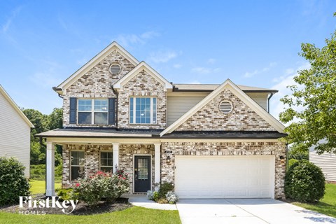 a brick house with a white garage door