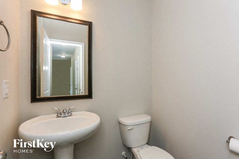 a bathroom with a sink and a mirror and a toilet