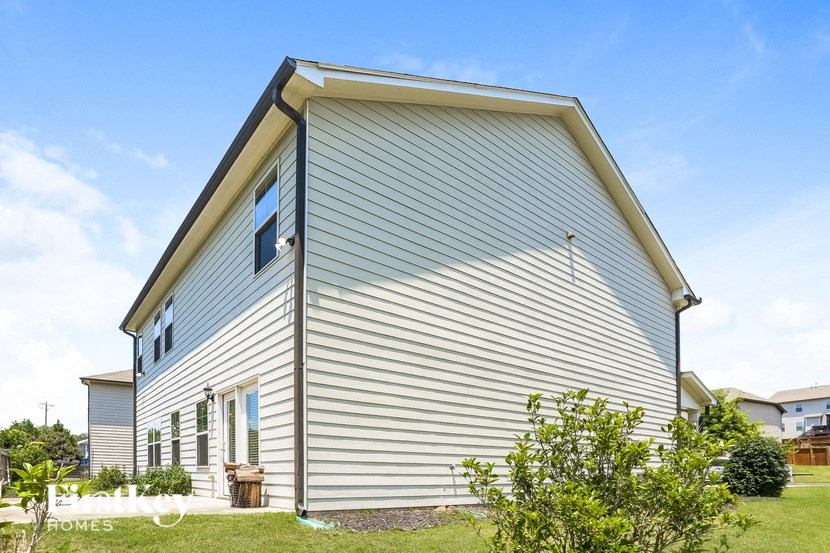 the side of a house with a blue vinyl siding