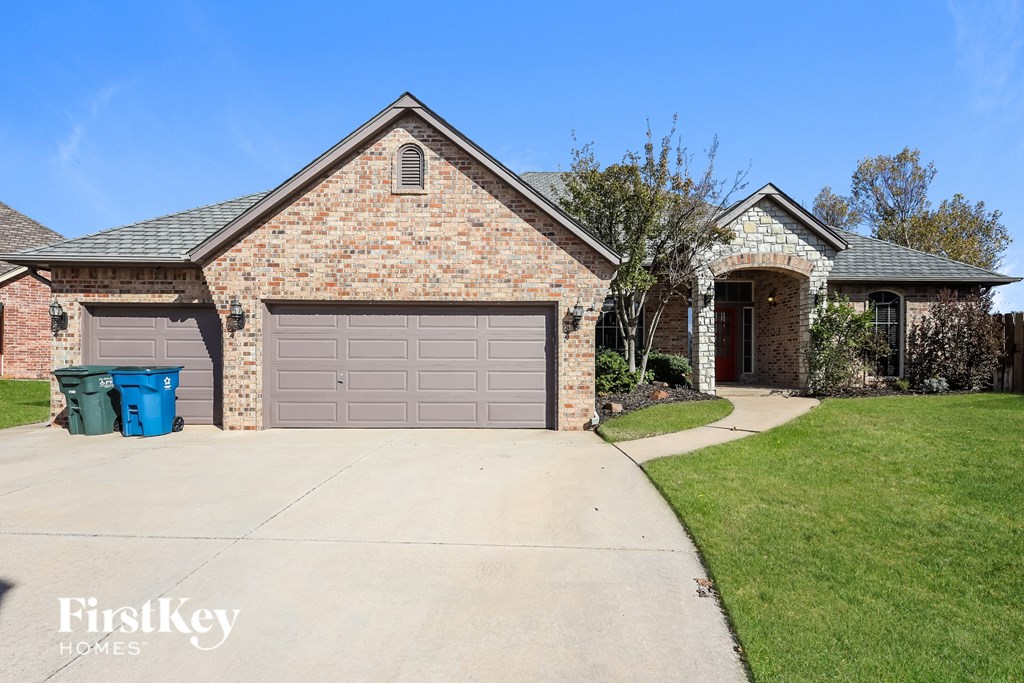a large brick house with a garage and a driveway