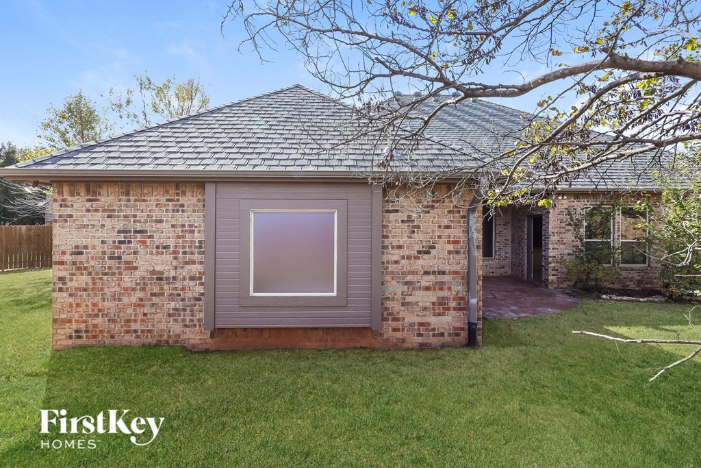 a small brick house with a window on the side of it
