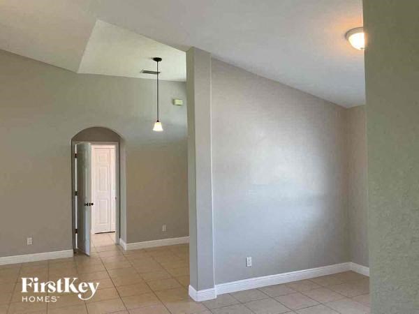 A room with a FirstKey Homes logo on the bottom left corner.