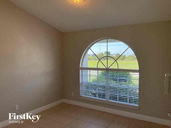 A room with a FirstKey Homes logo on the bottom left corner.