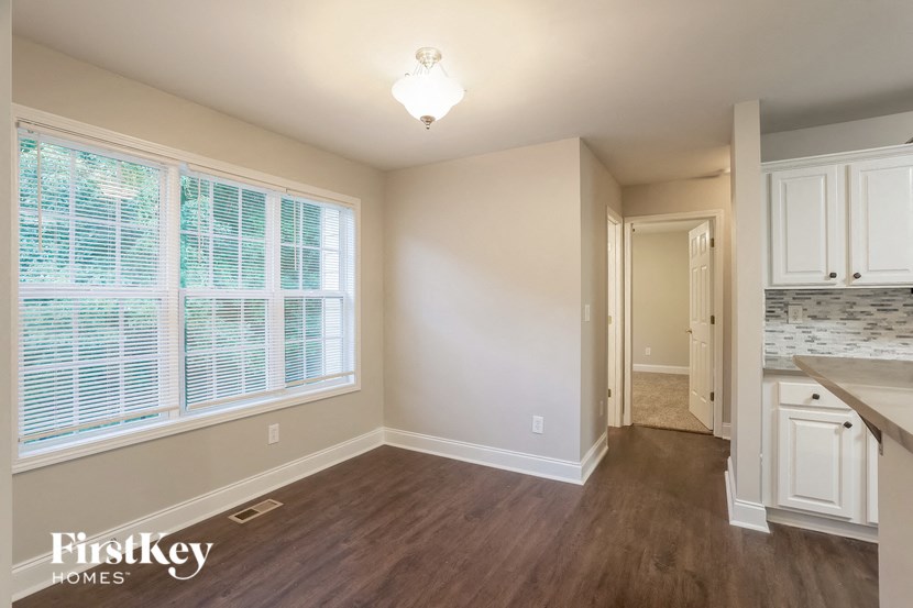 A room with a window and a wooden floor.