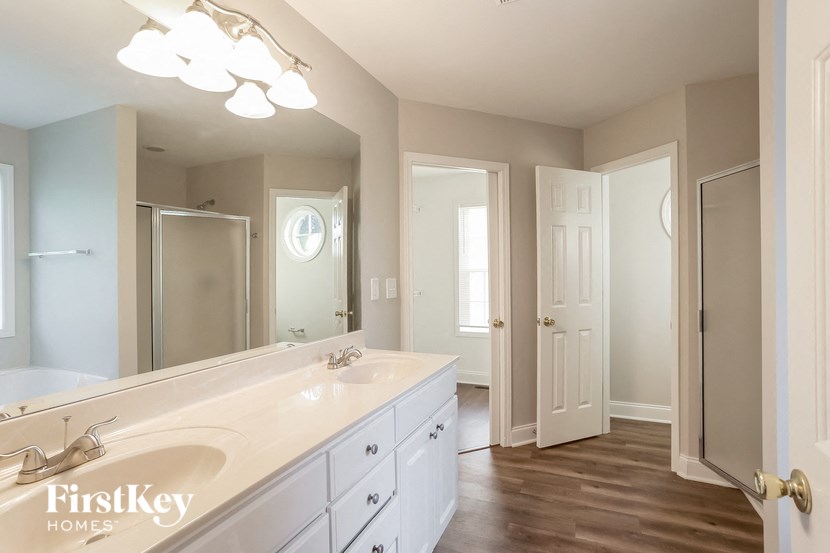 A bathroom with a large mirror and a sink.