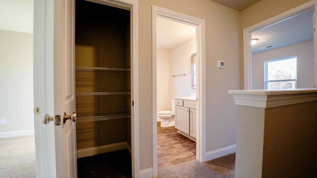 a view of a bathroom with a toilet and a closet
