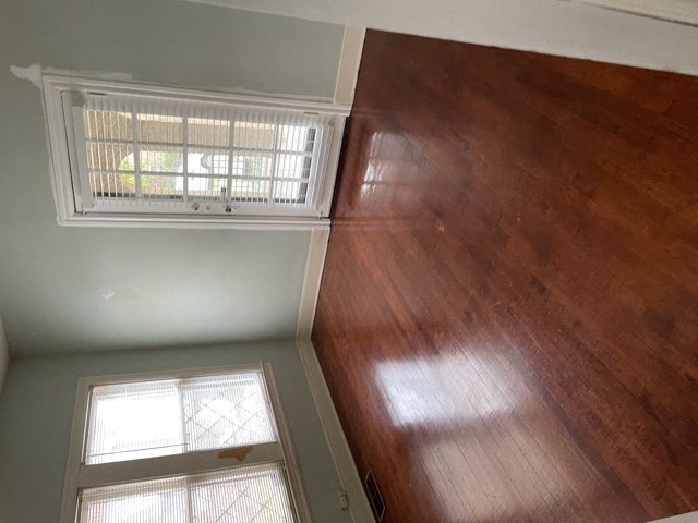 A wooden floor in a room with a window.