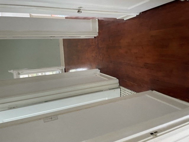 A white appliance with a brown wall behind it.