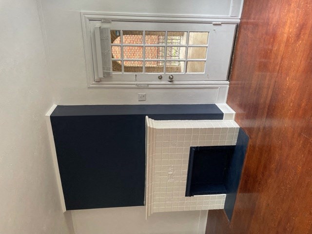 A kitchen with a black countertop and a white oven.