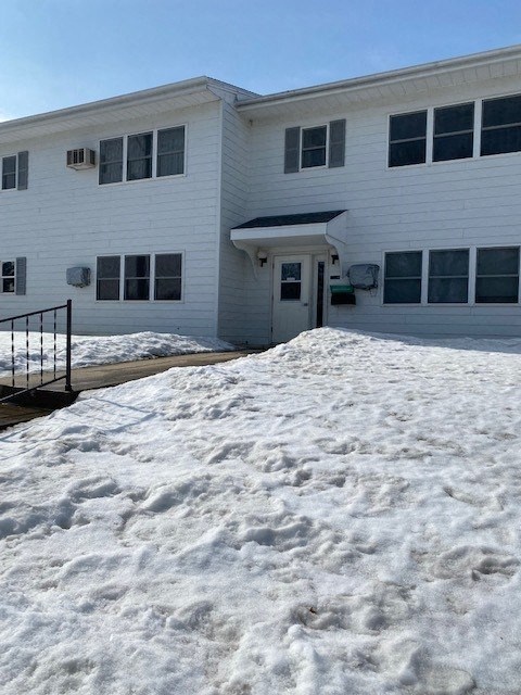 a white building with snow in front of it