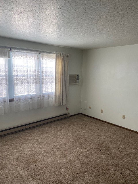an empty room with curtains and a window