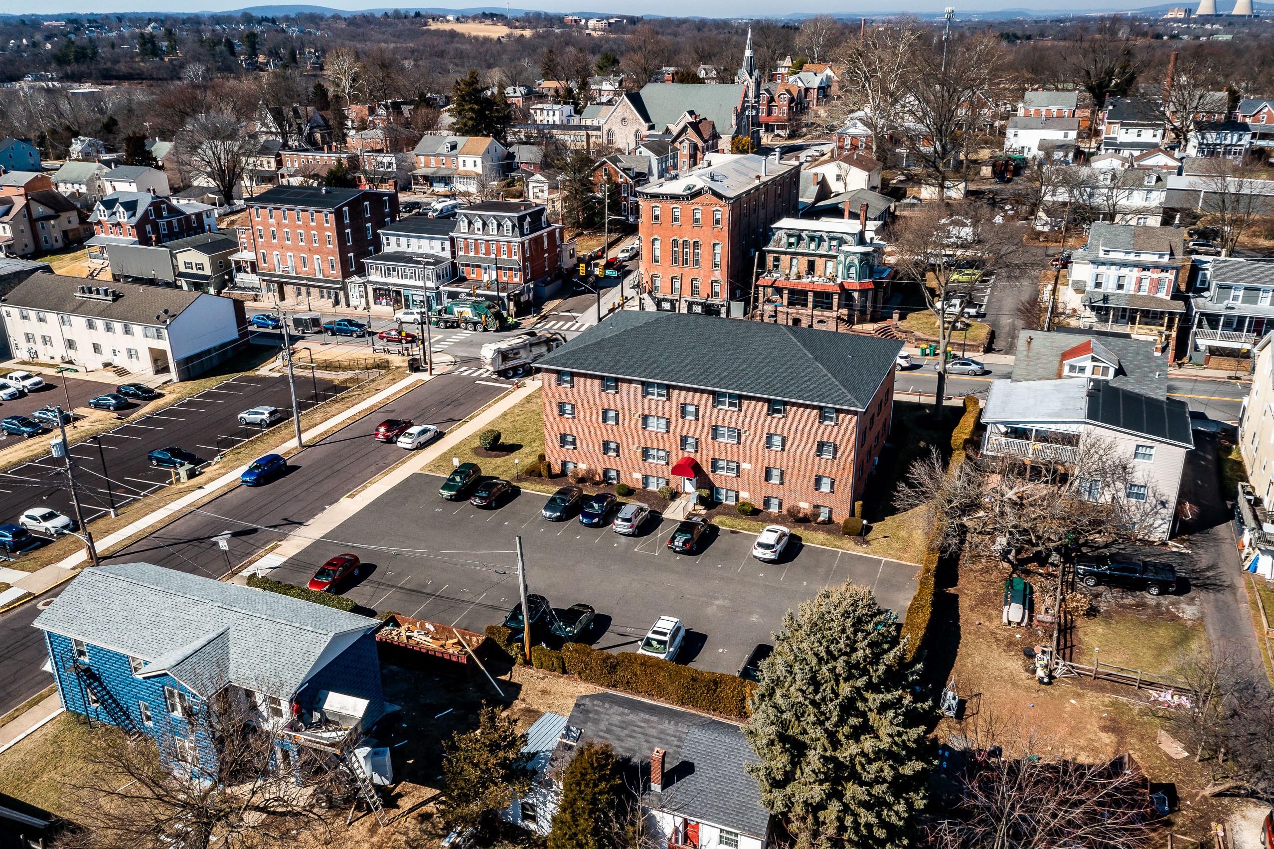an aerial view of a city with a pink building
