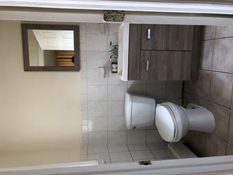 a small bathroom with a toilet and a mirror
