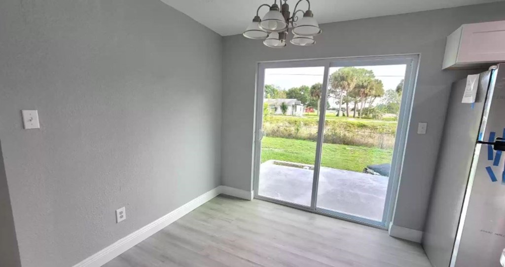 a living room with a sliding glass door and a view of a yard