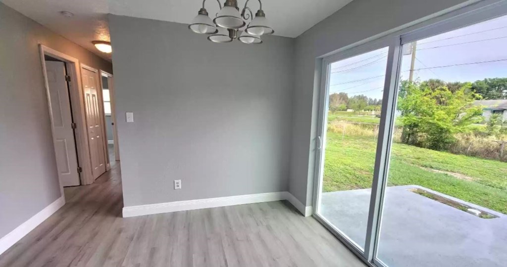 a living room with a large window and a wooden floor