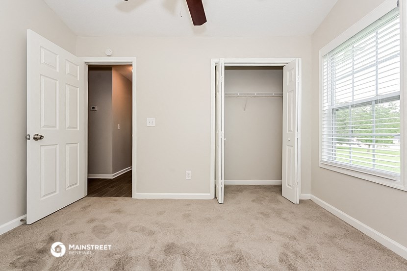 a bedroom with a closet and a door to a closet