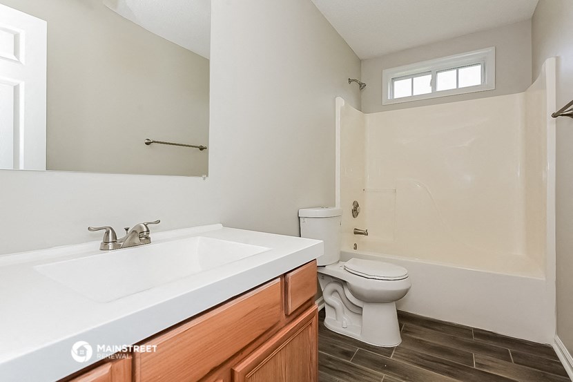 a bathroom with a toilet and a sink and a mirror