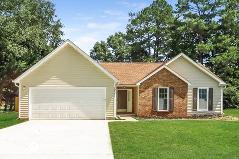 a house with a white garage door and a lawn