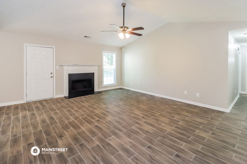 the living room with wood flooring and a fireplace
