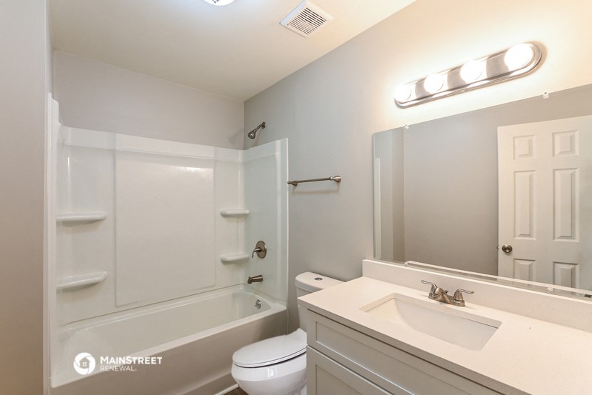 a bathroom with a sink and a toilet and a shower