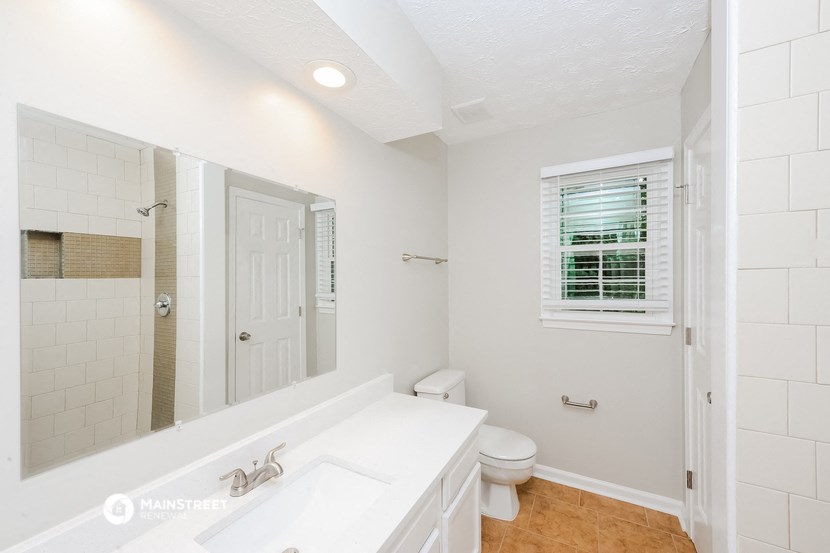 a bathroom with a sink and a toilet and a mirror