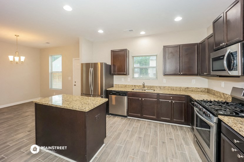 a kitchen with stainless steel appliances and granite counter tops
