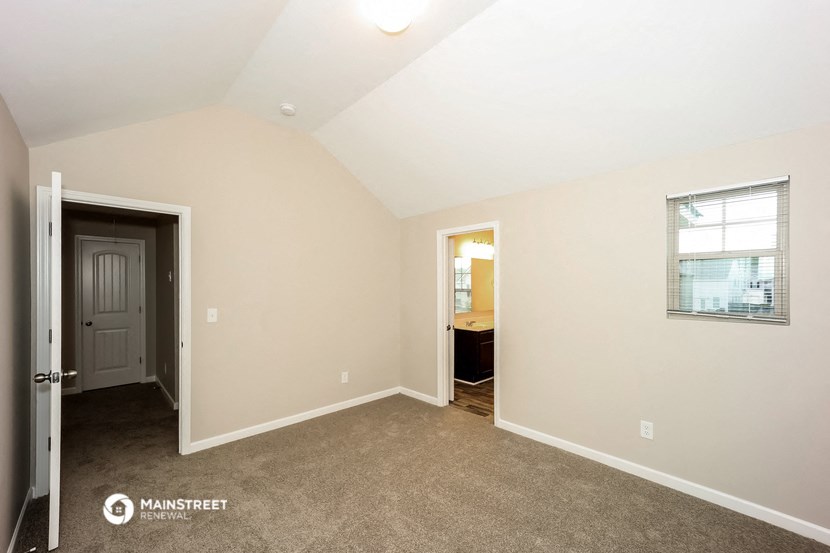 the master bedroom is spacious and has a door to the bathroom