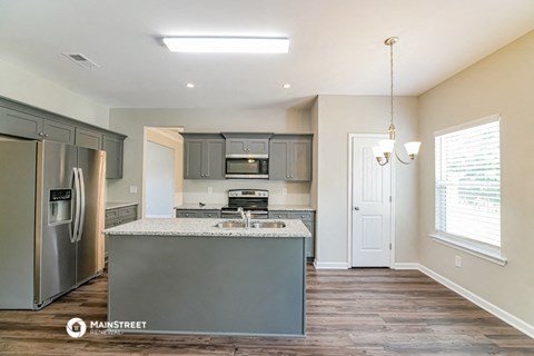 a kitchen with stainless steel appliances and a counter top