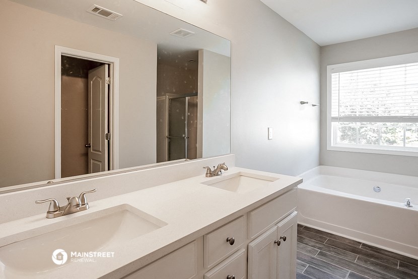 a bathroom with two sinks and a large mirror